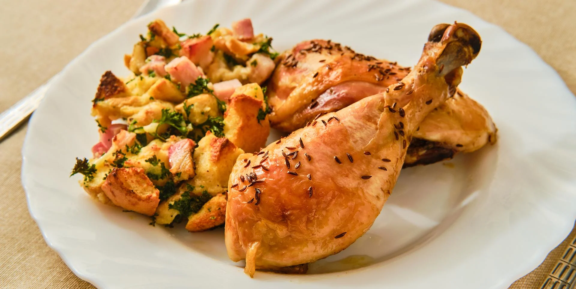 A plate with chicken leg and stuffing.