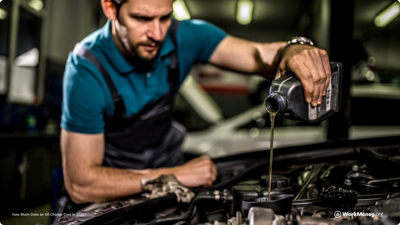 Man changing his oil under the hood of his car