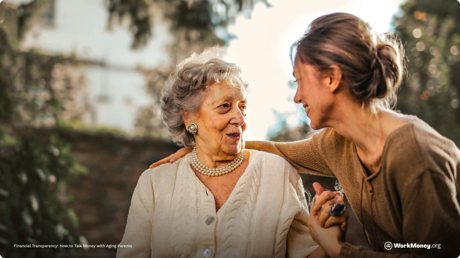 A woman hugs her aging mother smiling.