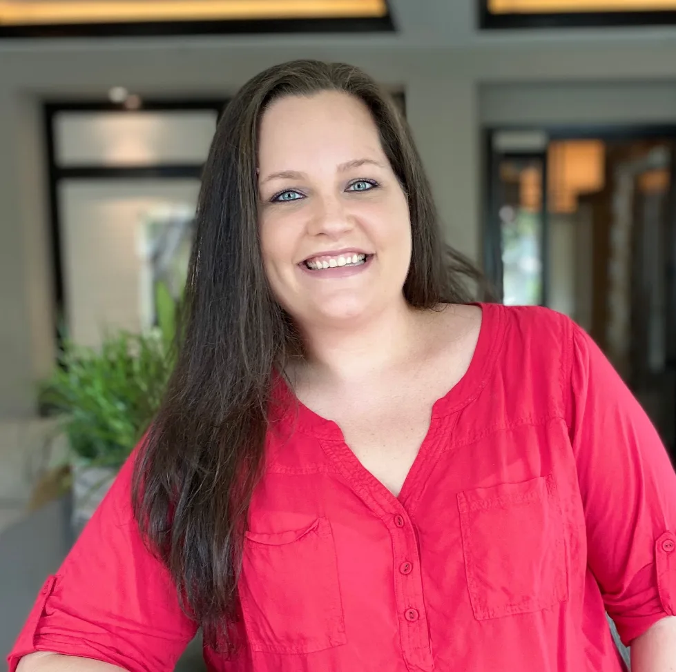 Dori Zinn in a red shirt smiling