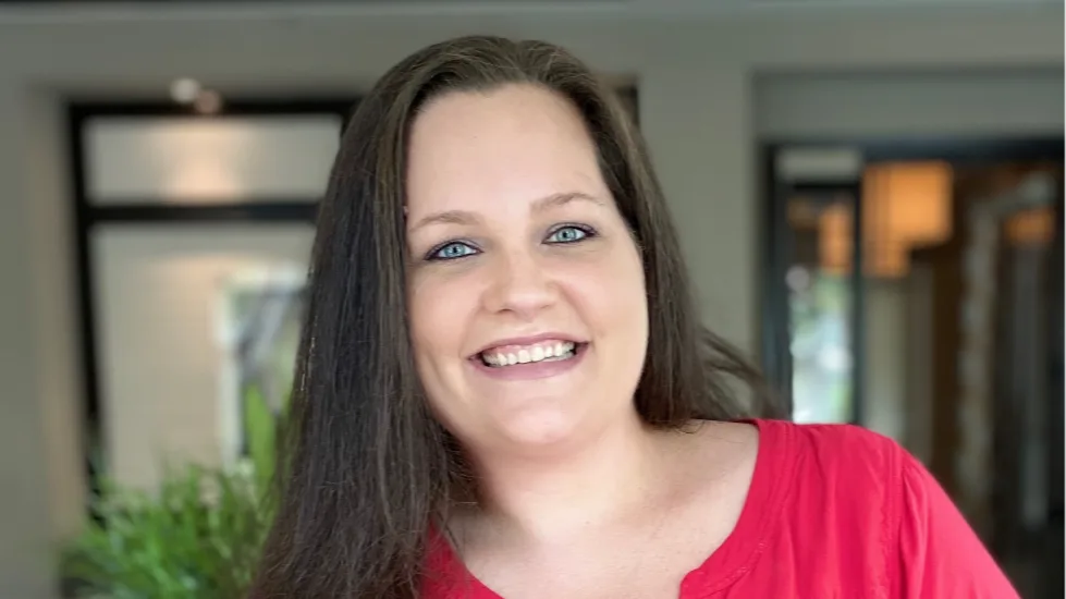 Dori Zinn in a red shirt smiling