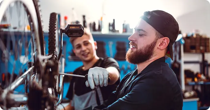 Two men working on a bike