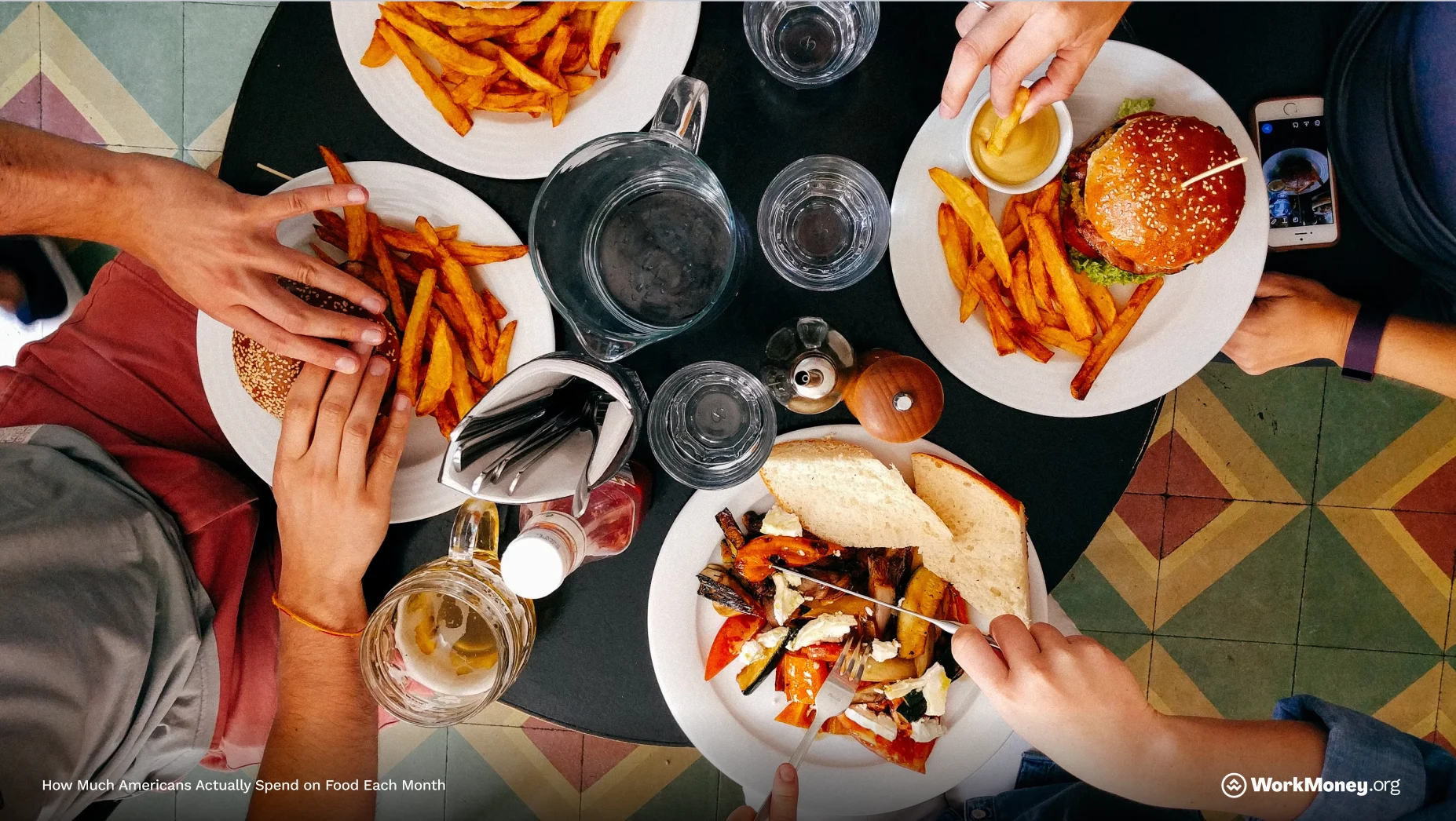 Table of food with hands reaching for plates