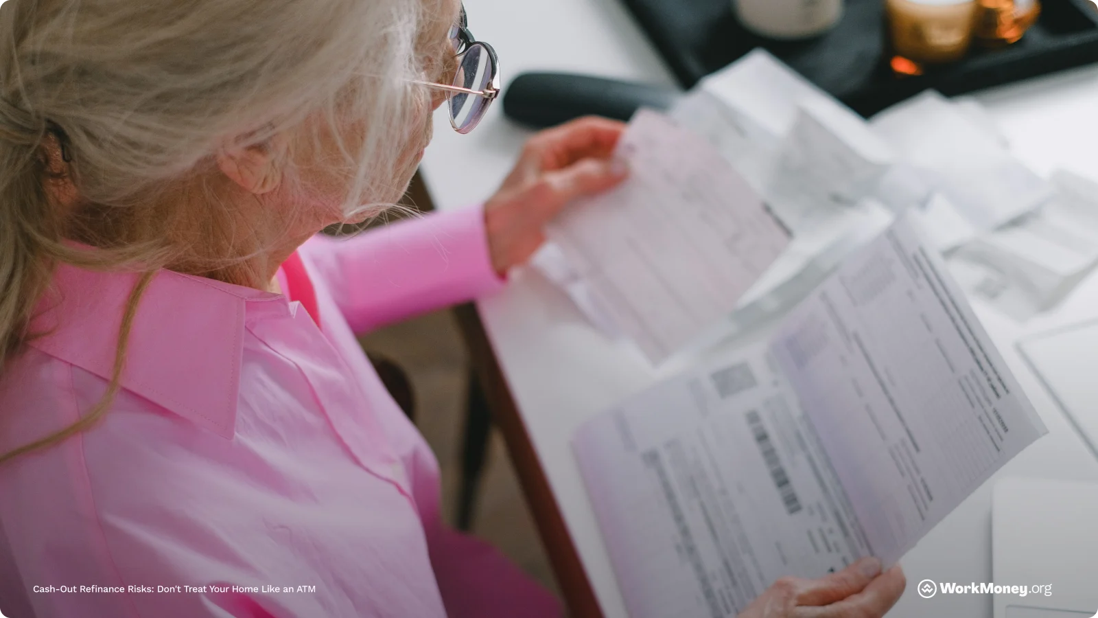 An older woman looks over some bills