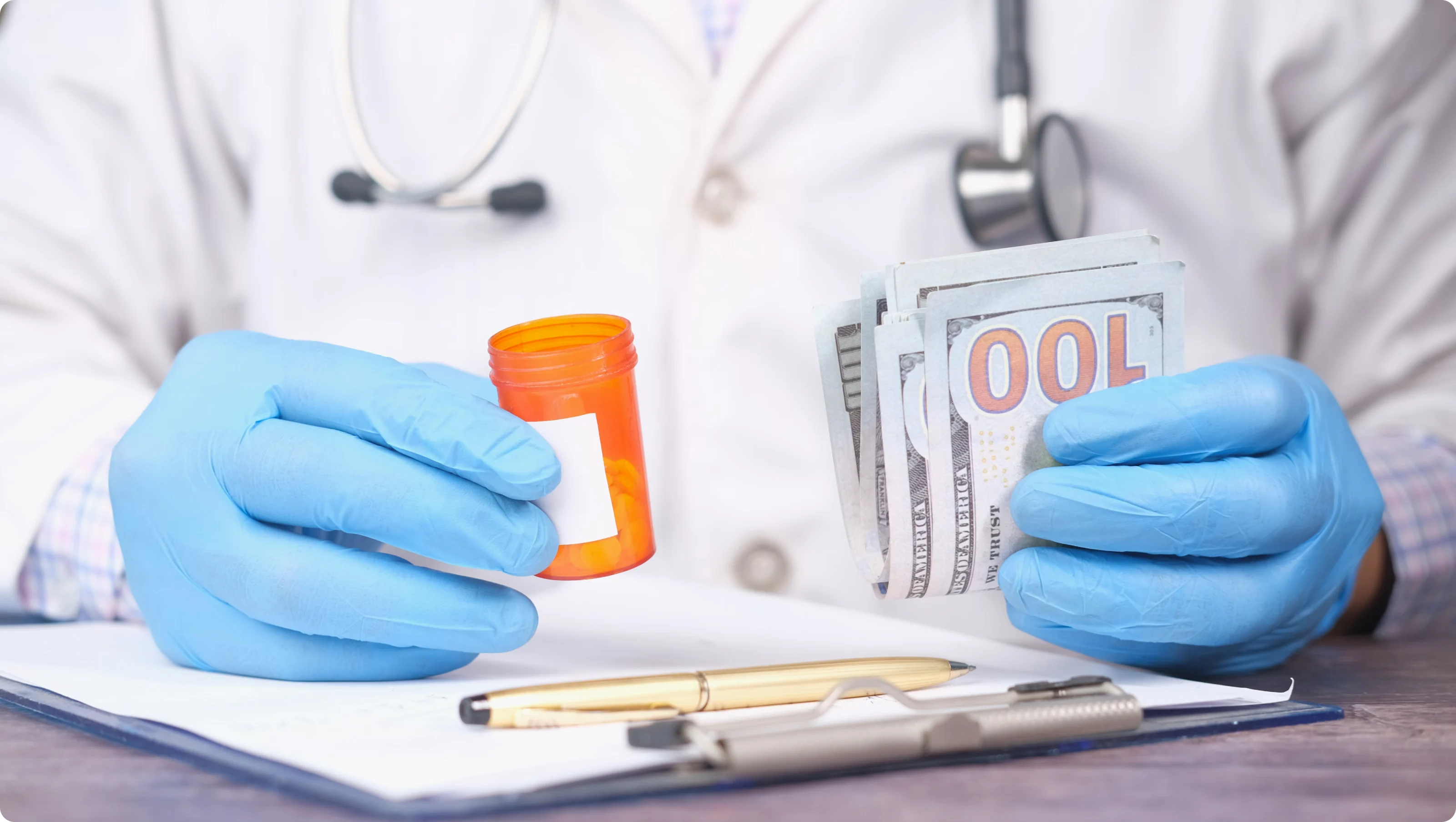 A man holds a prescription bottle in one hand and a handful of money in the other.