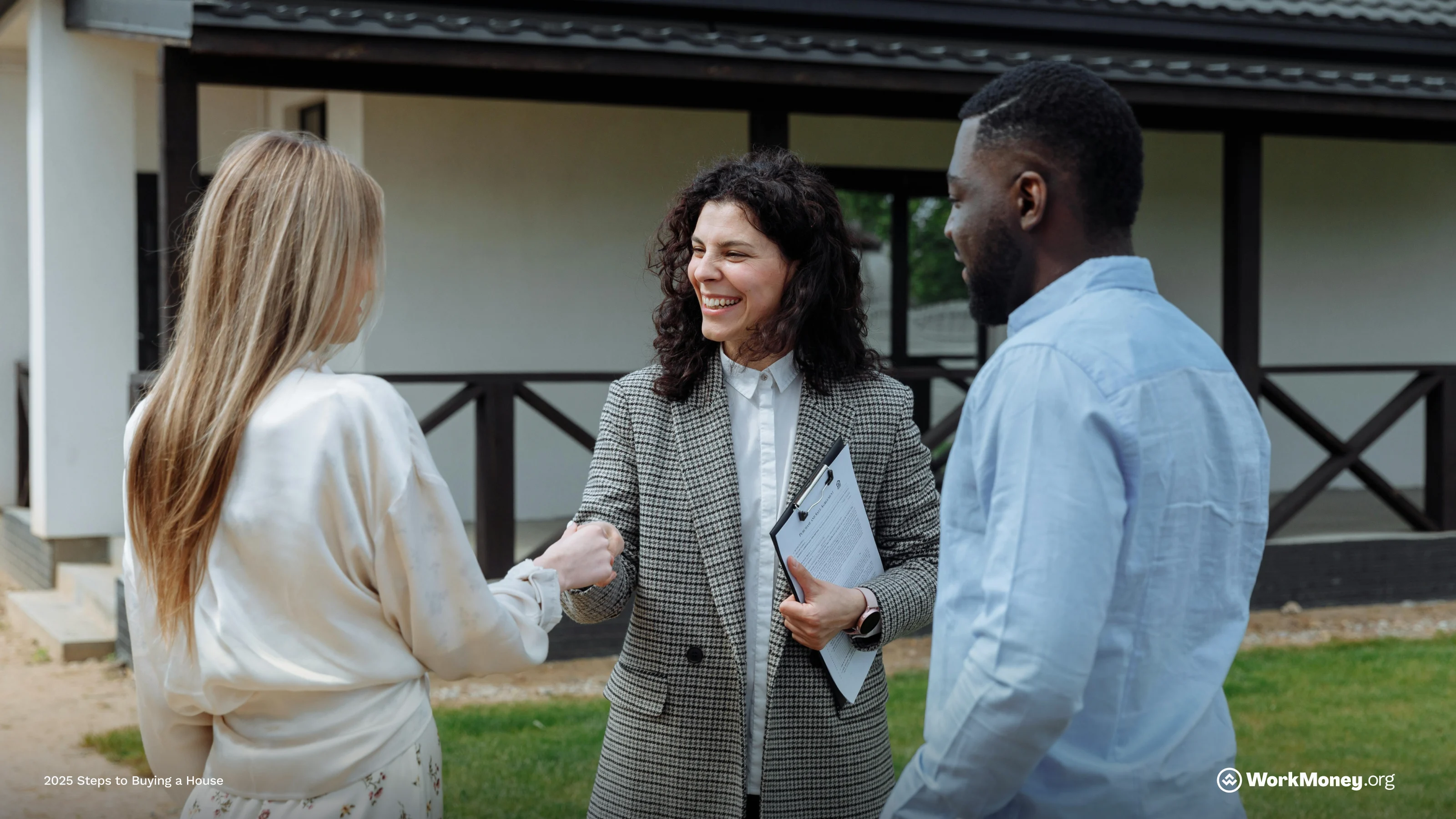 Couple buying a home and shaking hand of realtor