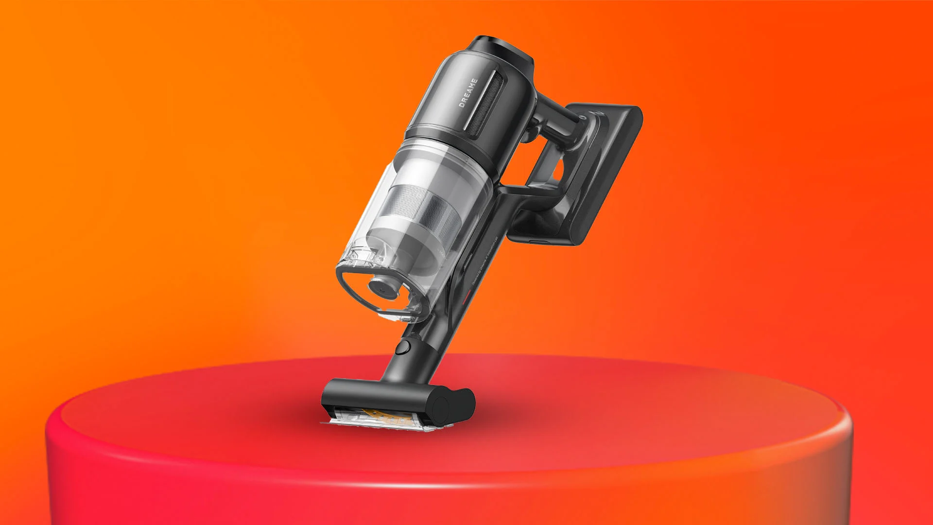 Svart handdammsugare på en röd piedestal mot en orange bakgrund.