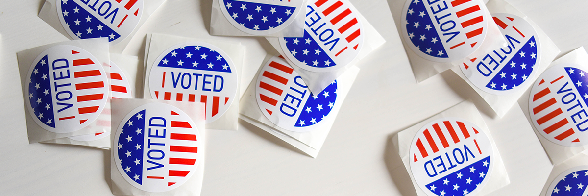 A loose pile of red, white and blue, Voted stickers.