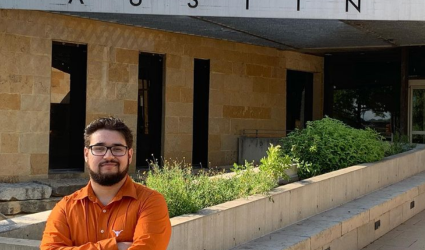 Mayoral candidate Phil Brual, standing in front of Austin City hall wearing a UT Austin shirt