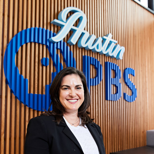 Nancy Pollard stands in front of the Austin PBS sign
