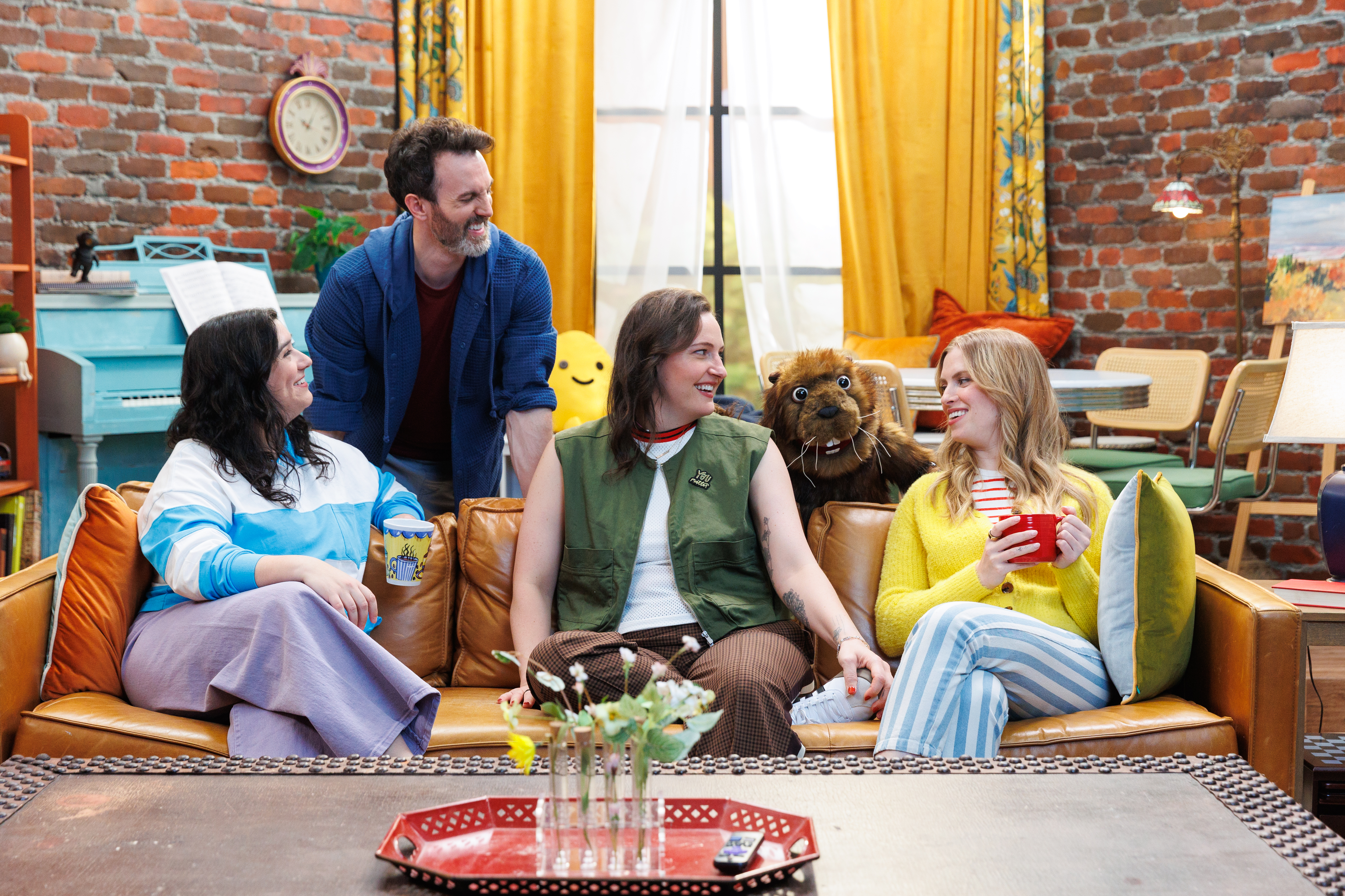 A group of adults sit on the How are we today couch.