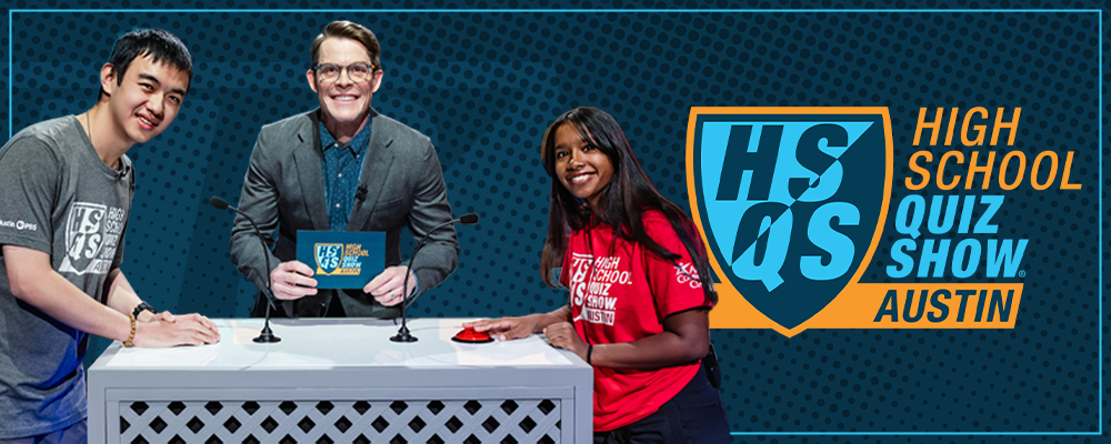High School Quiz Show Austin. Host Joe Hanson stands at a podium with two high school contestants..