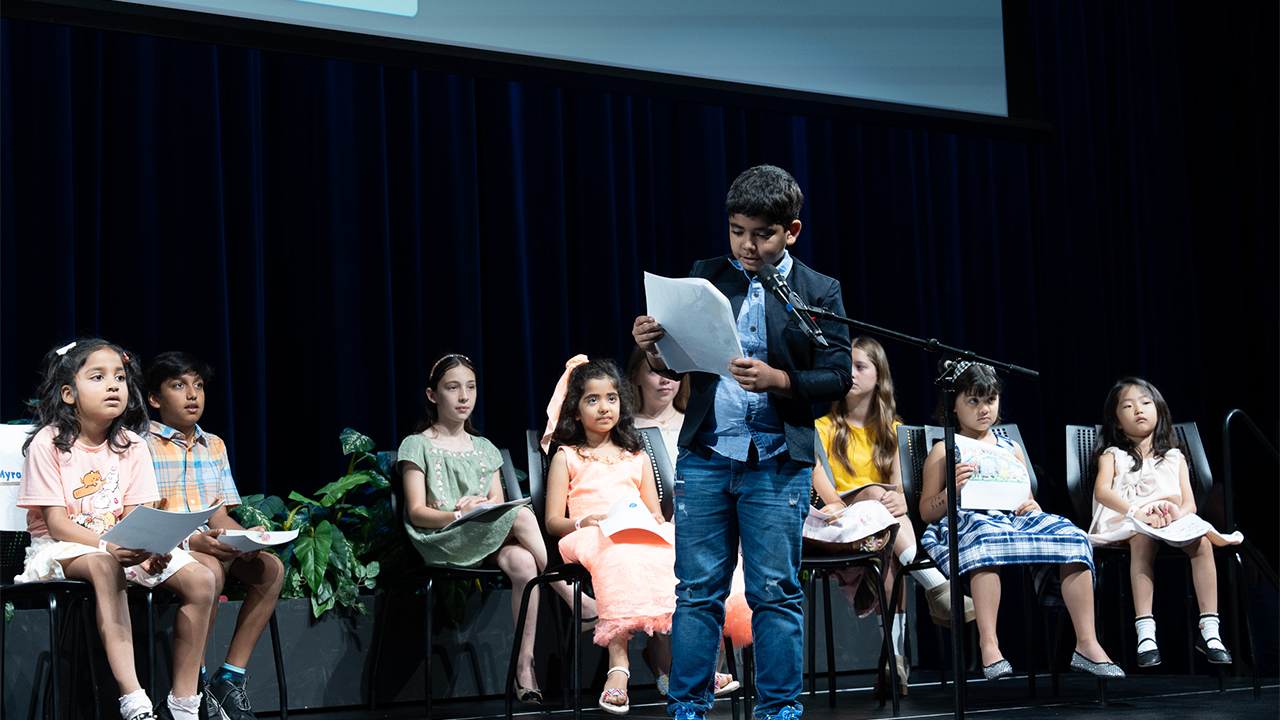 Children read the stories they wrote 