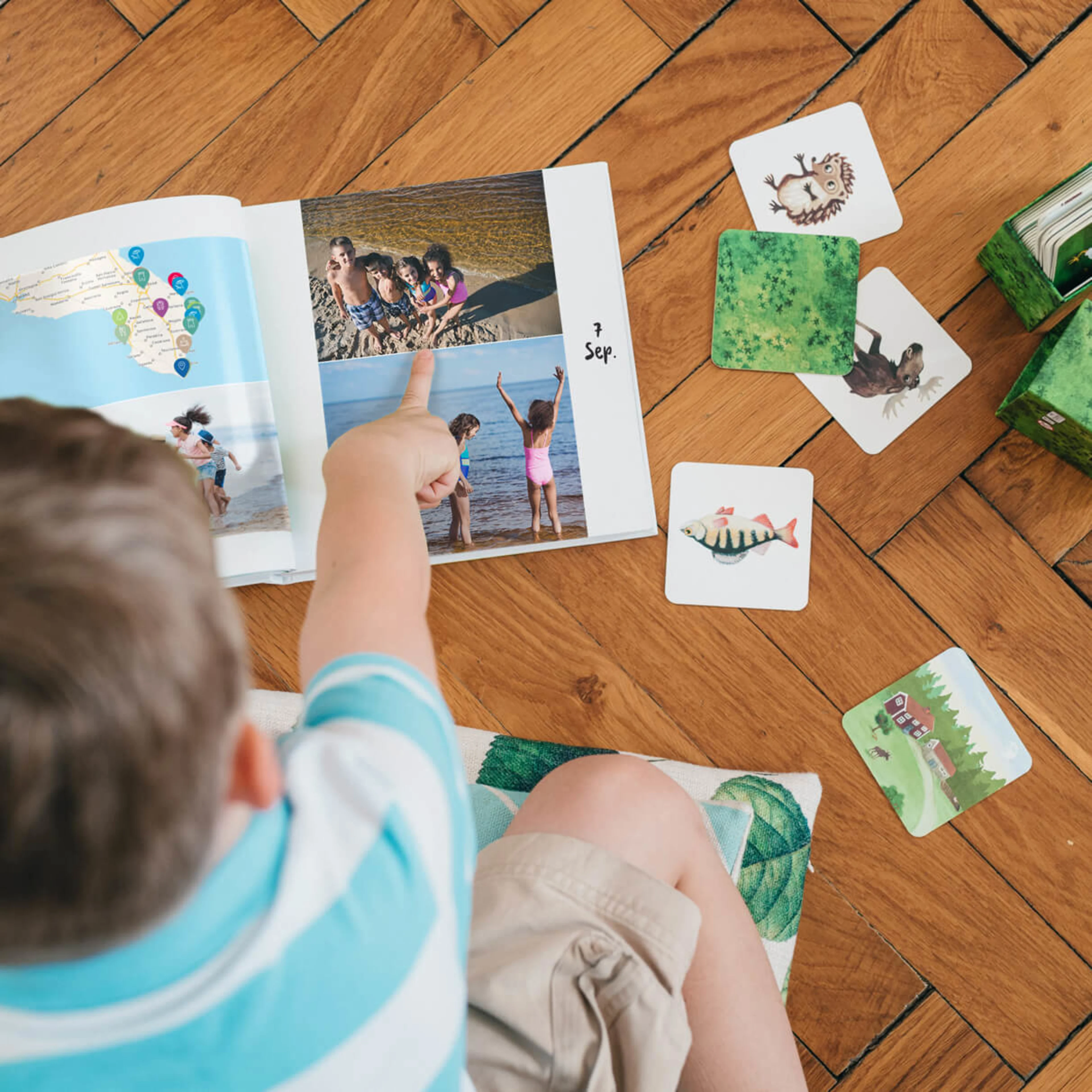 Child playing with family photo book