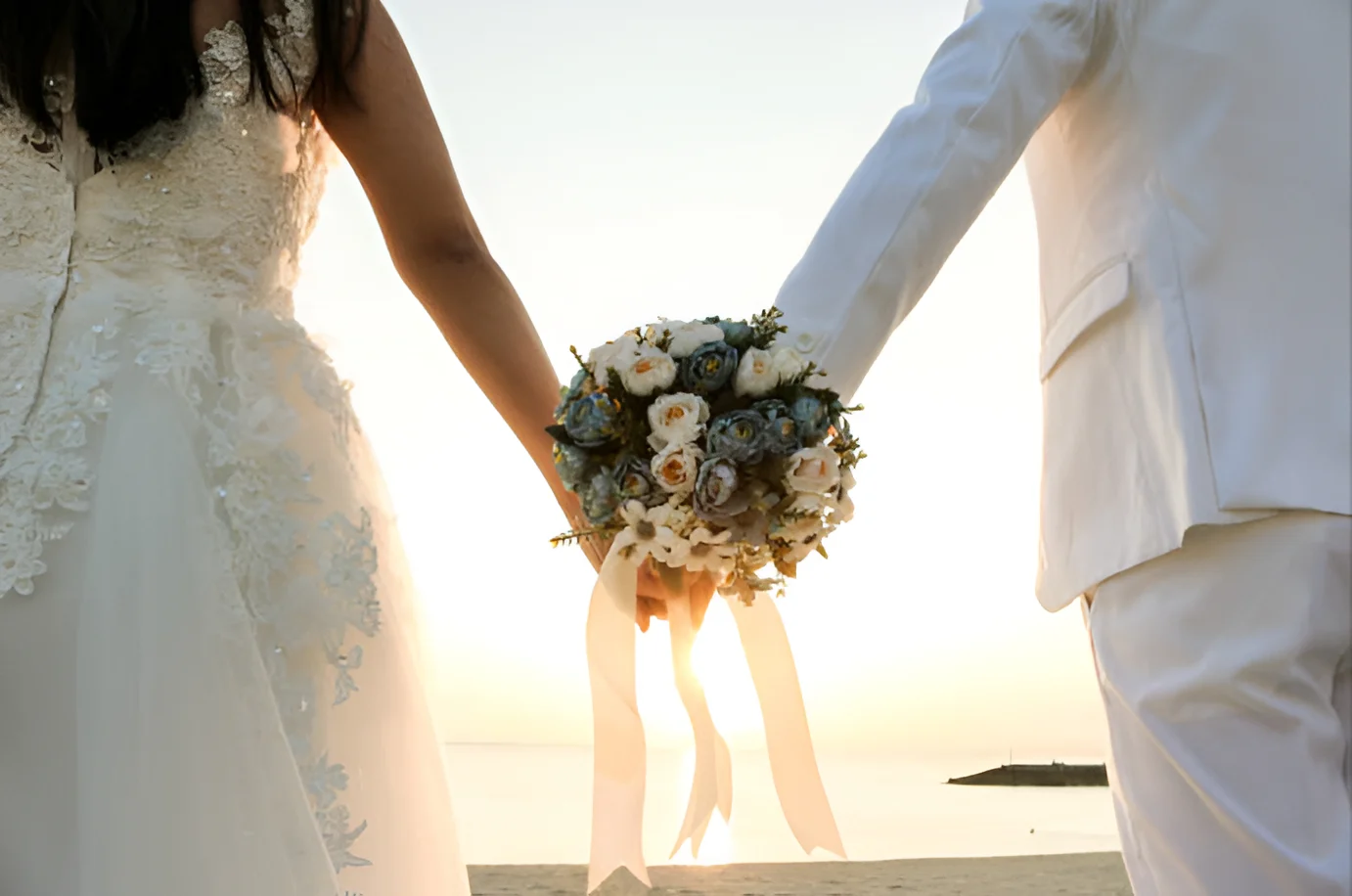 Wedding couple. Source: https://www.gettyimages.com/detail/photo/bouquet-at-the-beach-royalty-free-image/929904308