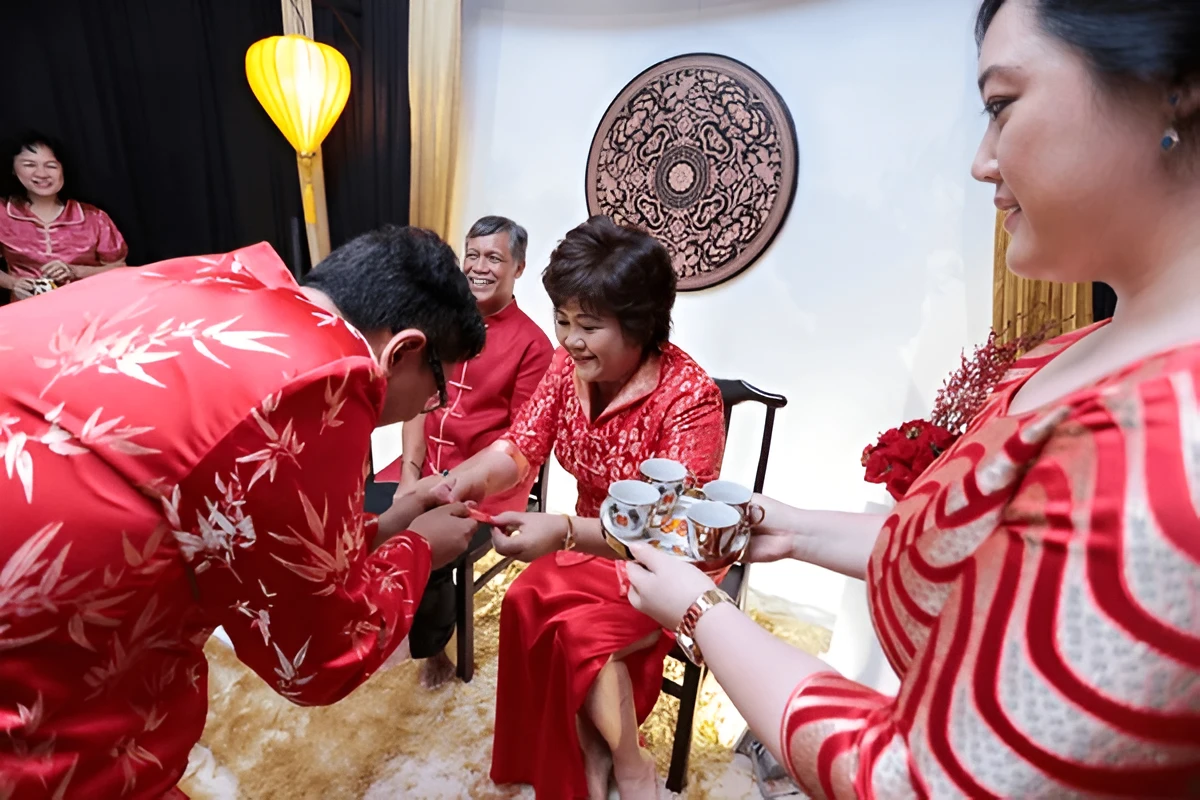 Groom offering tea to the bride's family during the tea ceremony. Source: https://www.shutterstock.com/image-photo/shah-alam-malaysia-august-31-2013-2273870715