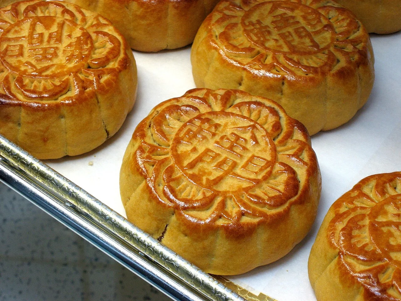 These Chinese mooncakes have Chinese characters meaning "salted egg yolk," which explains their filling. Source: https://thumb.wikimedia.org/wikipedia/commons/thumb/3/39/Moon_Cakes.jpg/1280px-Moon_Cakes.jpg?utm_source=en.wikipedia.org&utm_campaign=imageinfo&utm_content=thumbnail
