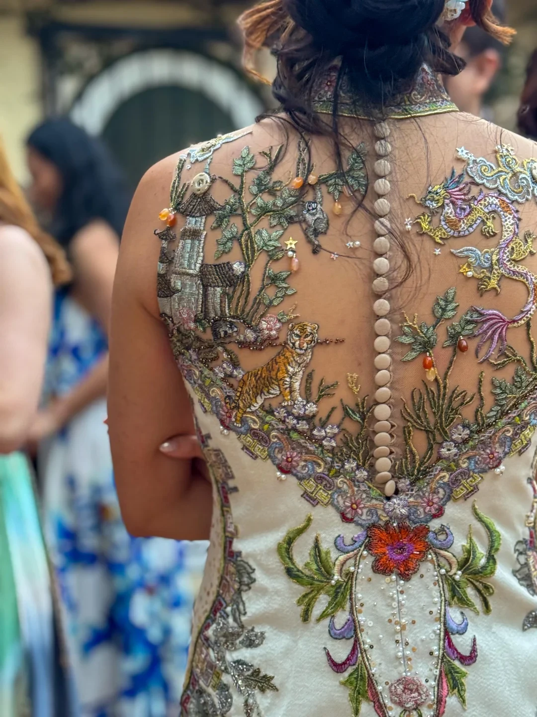 Family Zodiac signs adorn the back of the dress.