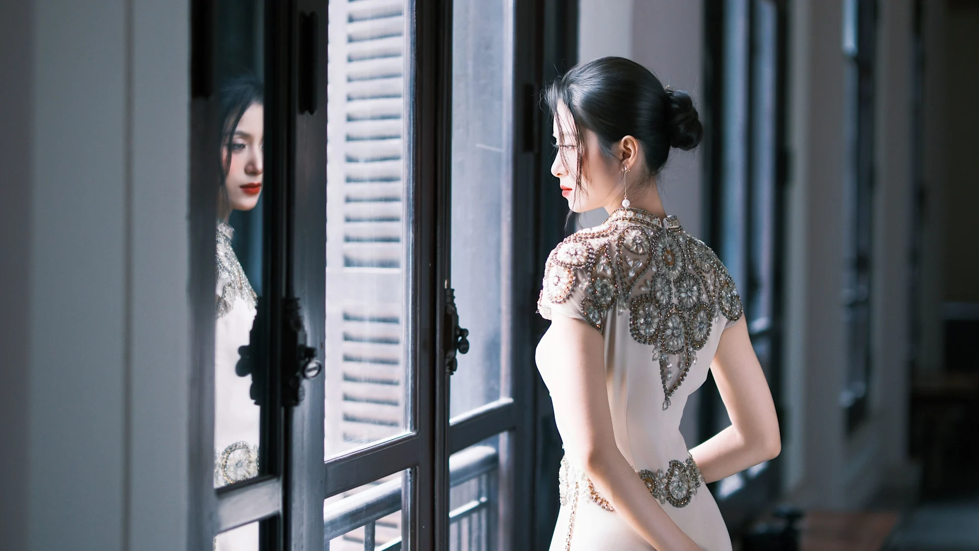 A simple bun perfectly balances this intricate dress.