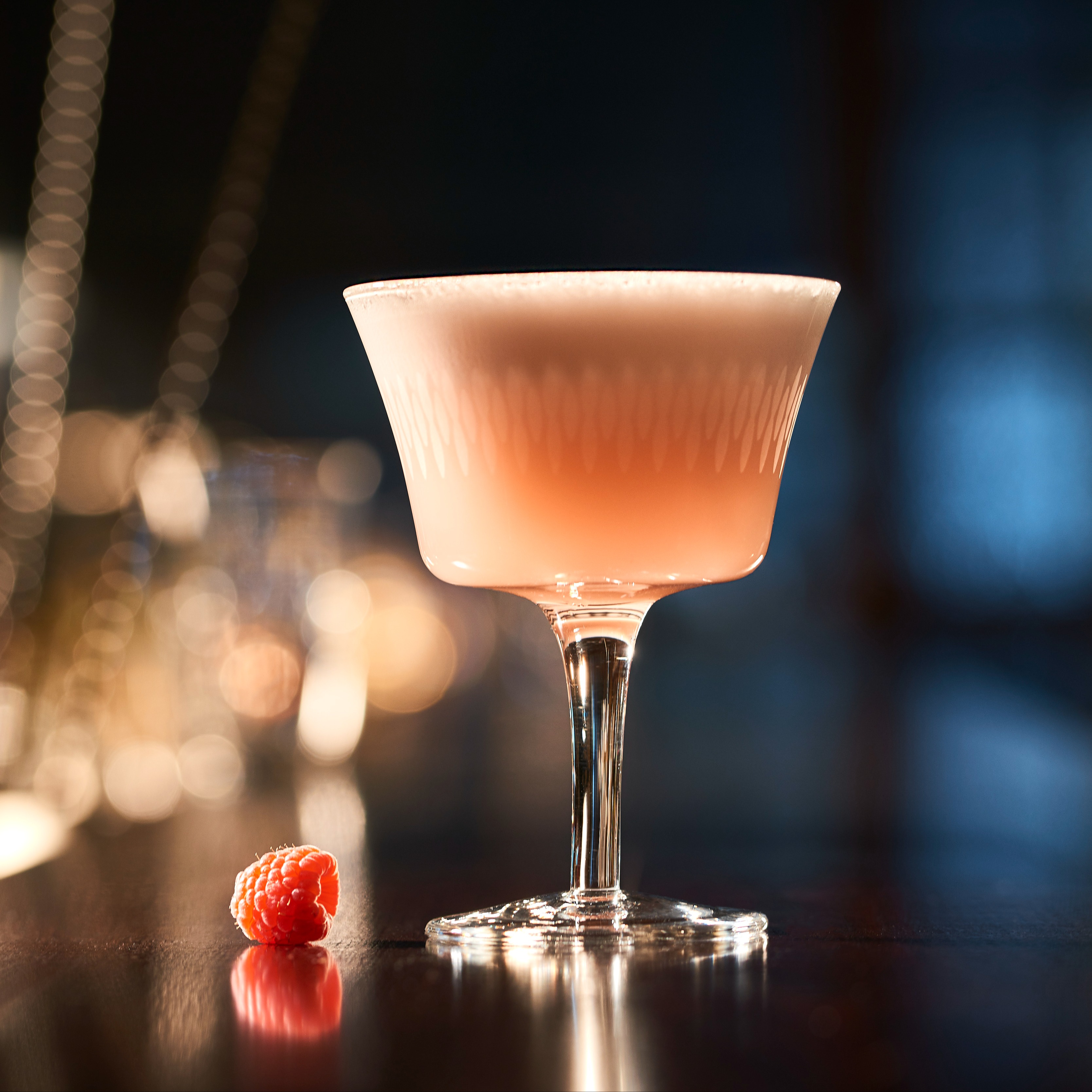 Non-alcoholic clover club cocktail with raspberries