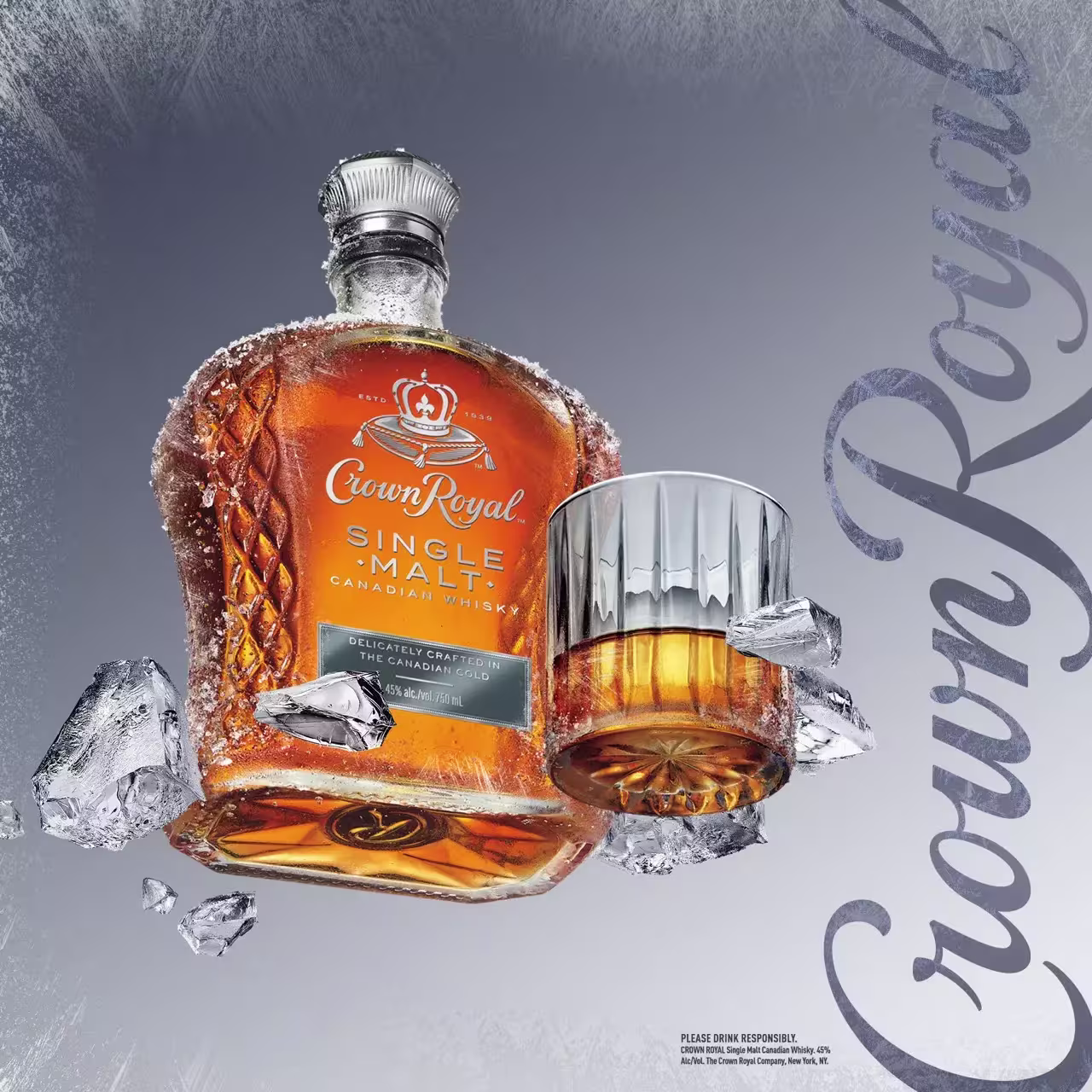 Crown Royal Single Malt Canadian Whisky bottle and a glass with whisky are surrounded by ice cubes, set against a silver background with Crown Royal written on the side.