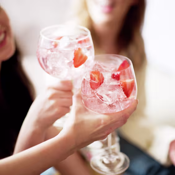 Pink gin cocktails with friends