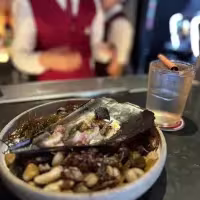Platillo de pescado con un gin tónic