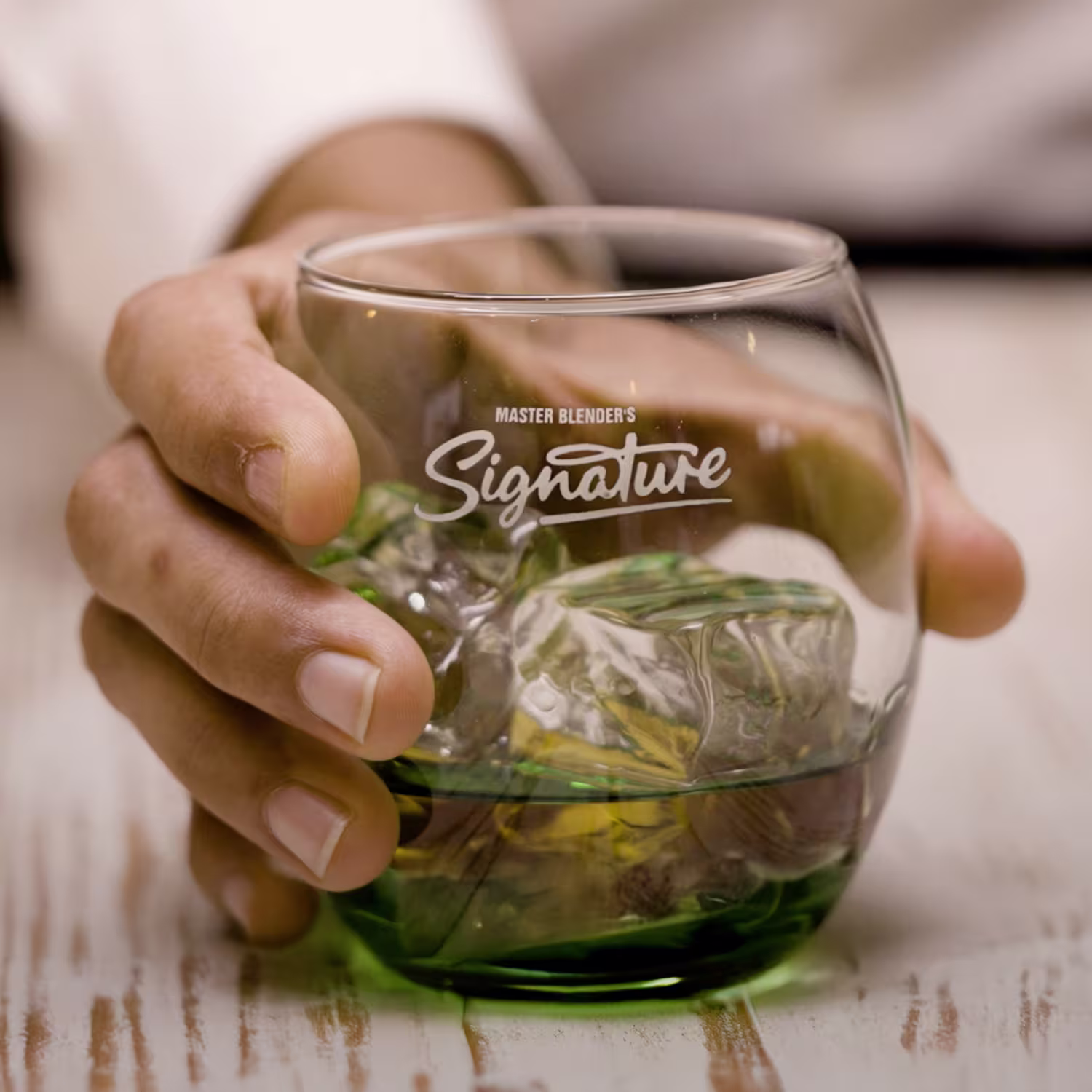 Signature Cocktail in hand on a table