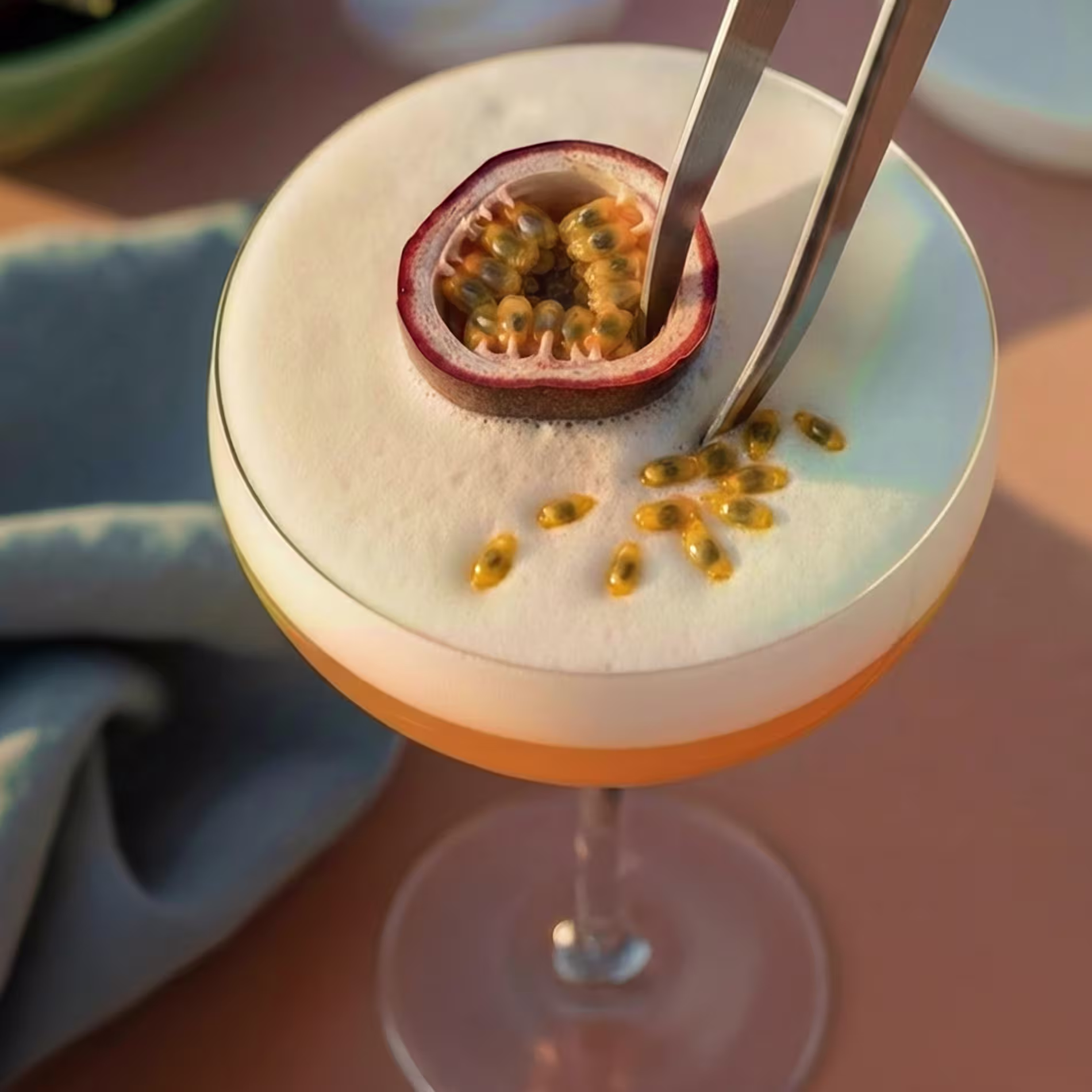 Half a passionfruit is placed face-up on top of the Pornstar Martini drink to garnish.