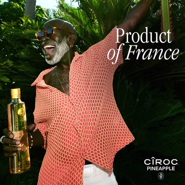 person with CÎROC pineapple in hand