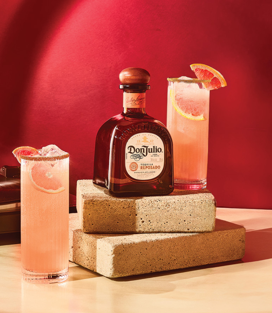 Don Julio Reposado Tequila next to 2 Paloma Cocktails