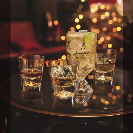 La imagen muestra 4 vasos de diferentes tamaños con whisky en ellos.