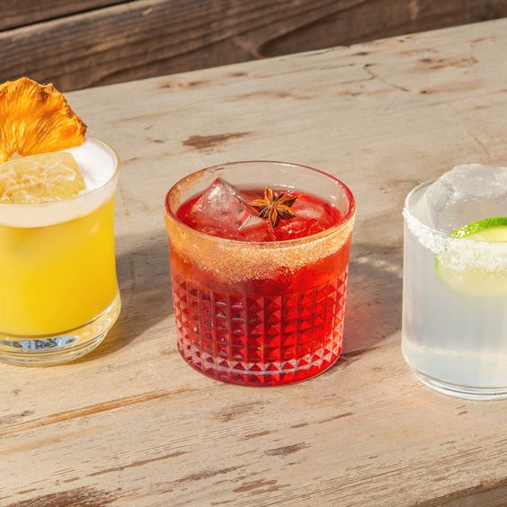 Three tequila cocktails on a shelf