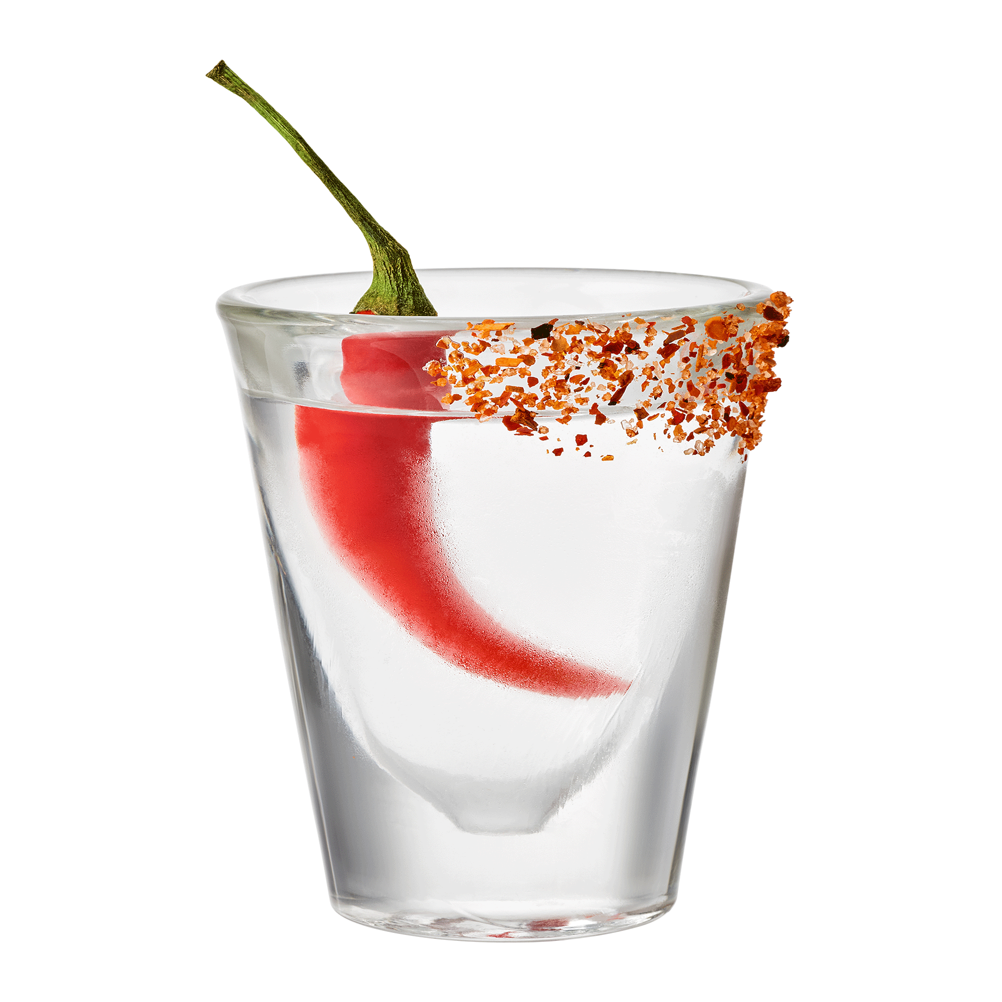 A clear glass of water with a red chili pepper inside and chili flakes on part of the rim, set against a white background.
