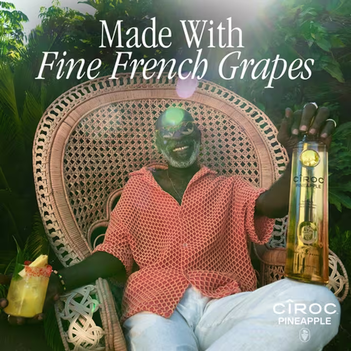 Cîroc Pineapple cocktail and bottle in persons hand