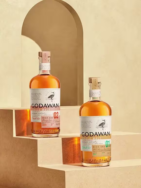 Two Godawan whisky bottles on stairs