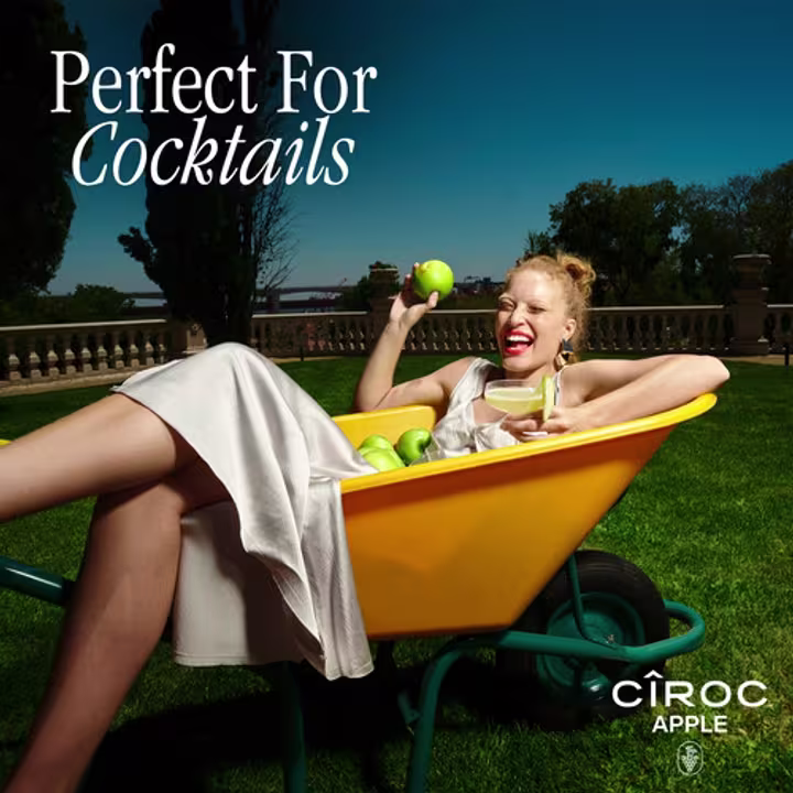 Person holding apple and CÎROC Apple cocktail