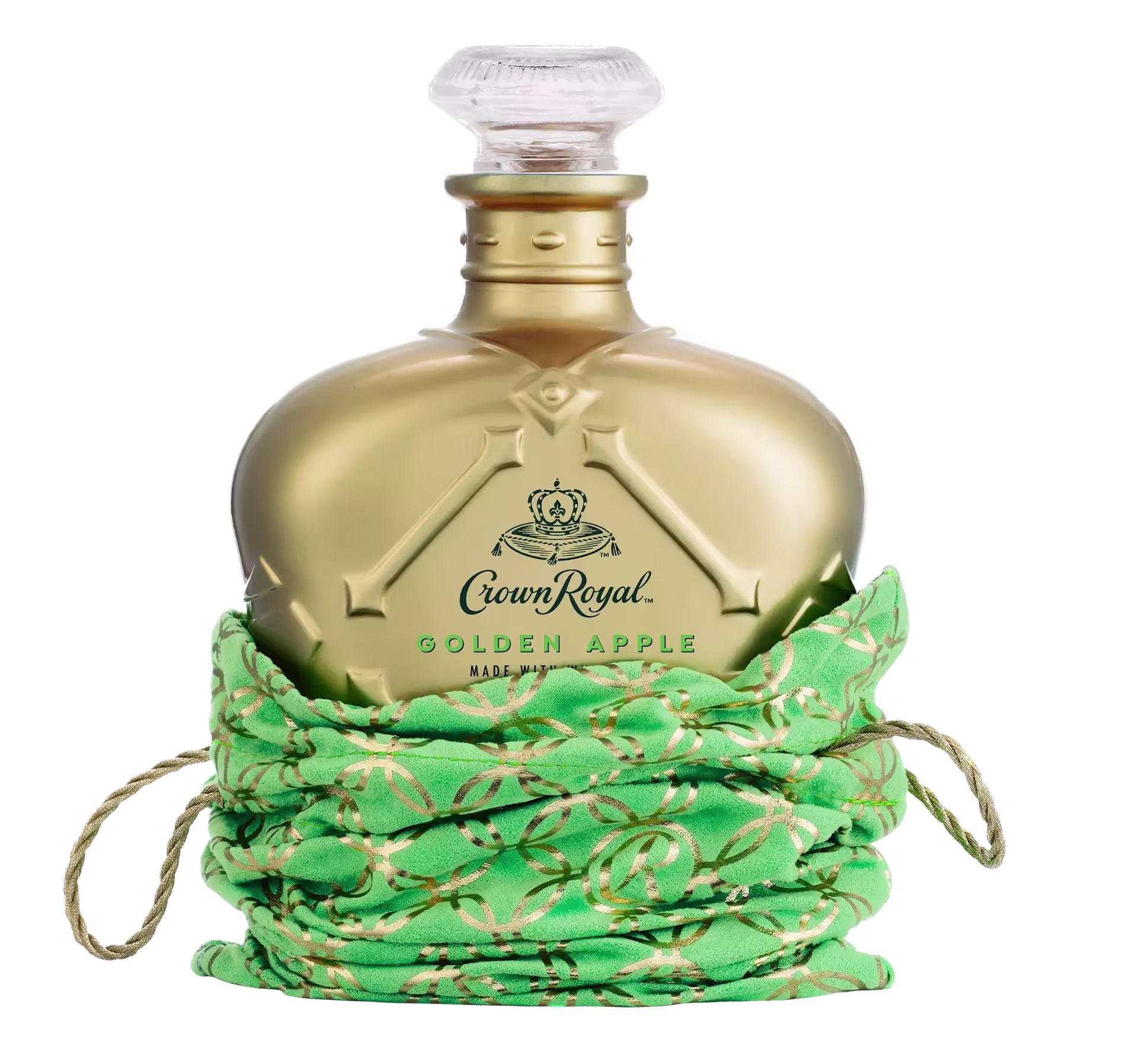 A gold-colored Crown Royal Golden Apple whiskey bottle sits in a green and gold drawstring bag against a plain background.