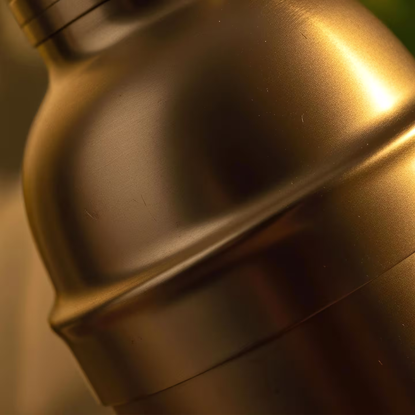 A close up of a copper cocktail shaker.