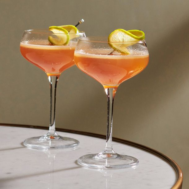 Two Hotel Nacional cocktails garnished with lime wheels served in coupe glasses