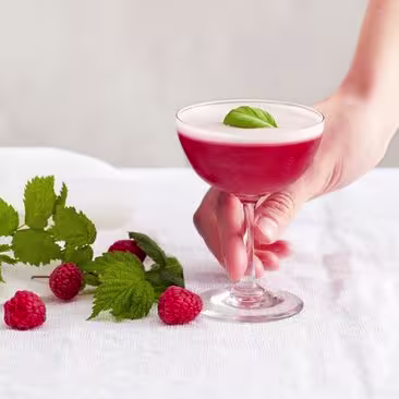 Non-alcoholic clover club cocktail with raspberries