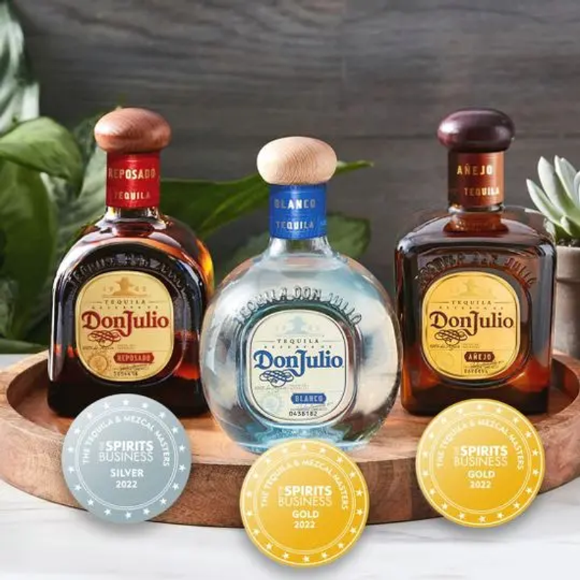 Don Julio 1942 on a tray surrounded by people drinking from champagne flutes