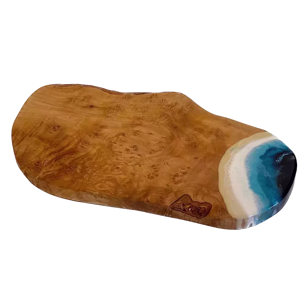 Wooden serving board with a live edge design and a resin inlay resembling ocean waves on one end.