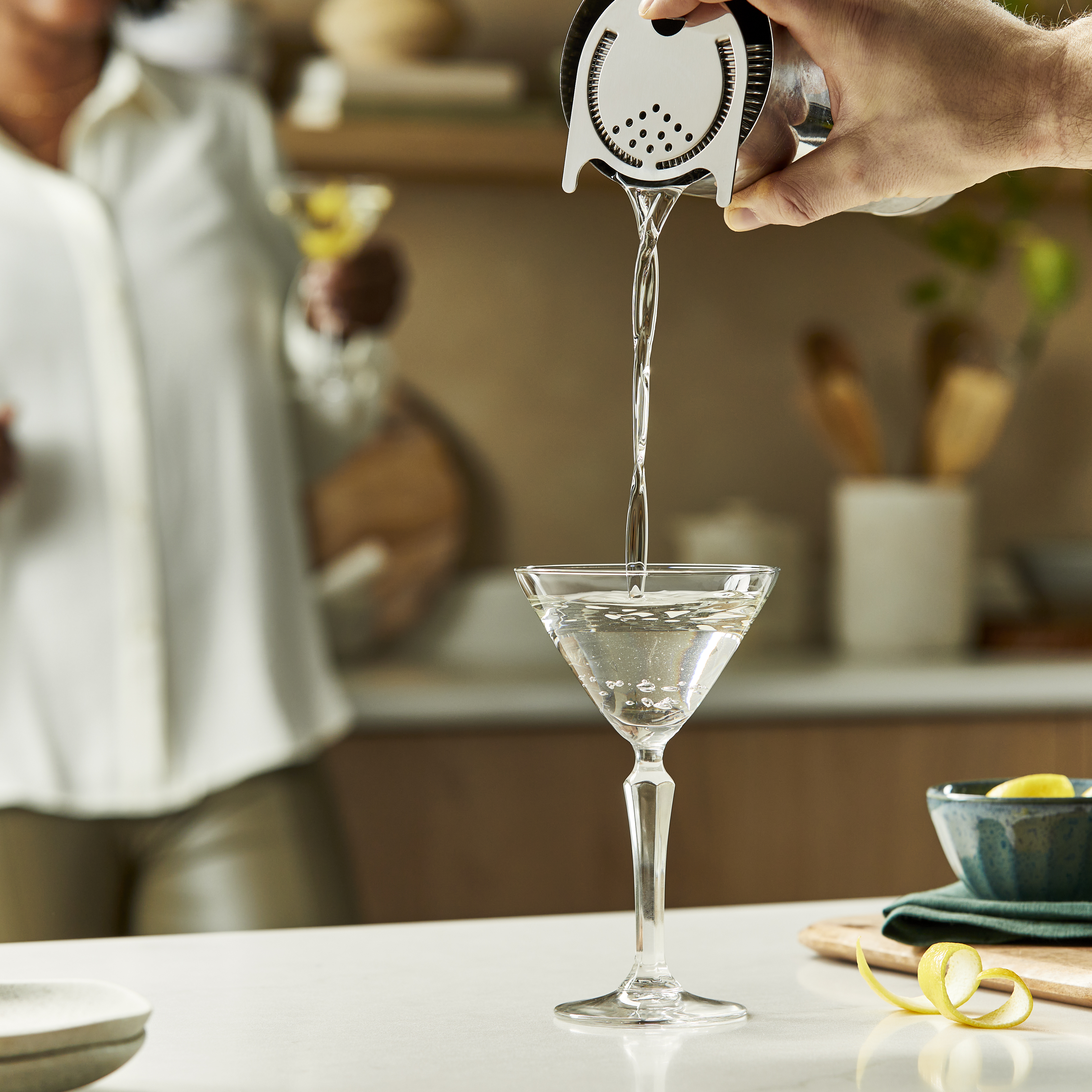 Straining a martini into a coupe glass