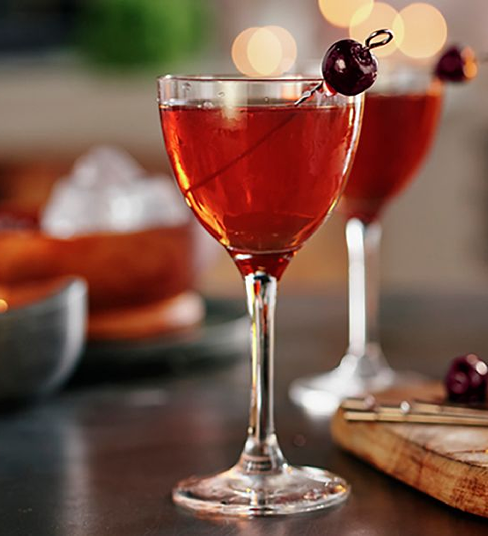 Rob Roy whisky cocktail made with Johnnie Walker Blue Label, served in a coupe glass with cherry garnish