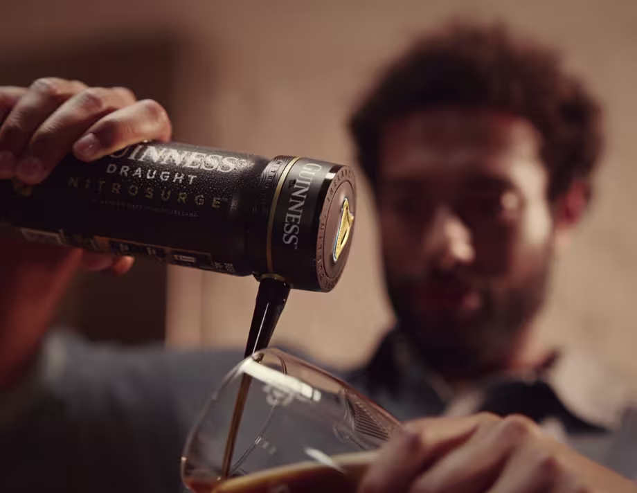 Guinness Nitrosurge Device Attached pouring into a glass.