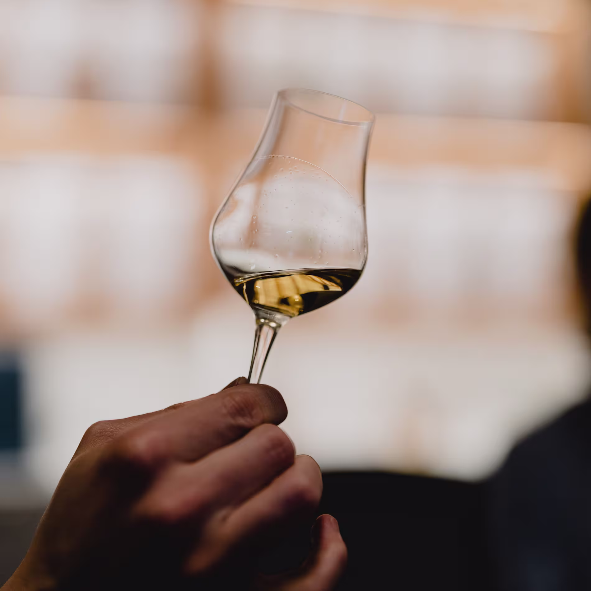 A small whisky glass held up to the light. 