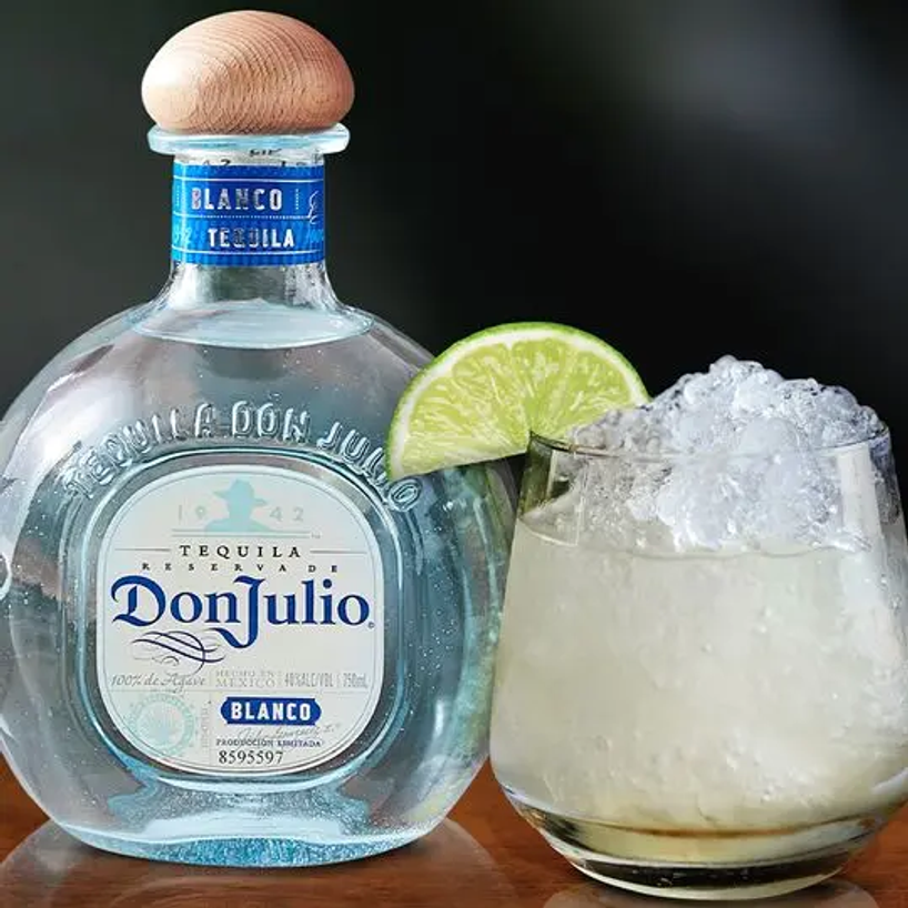Don Julio Blanco bottle next to a Whisky Cocktail