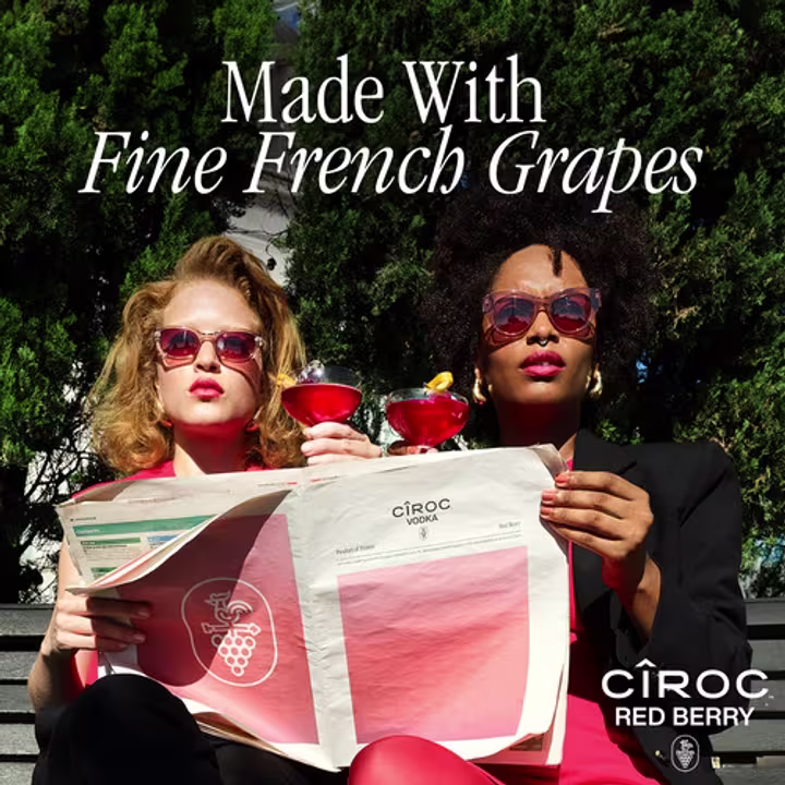 People holding a Ciroc magazine with a cocktail in their hands