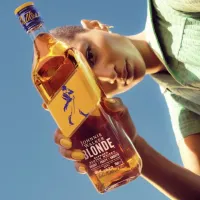 Una persona sosteniendo una botella de Johnnie Walker  Blonde